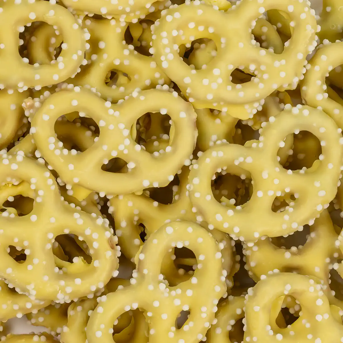 LEMON COCONUT YOGURT FLAVORED PRETZELS W/ WHITE NON PAREILS