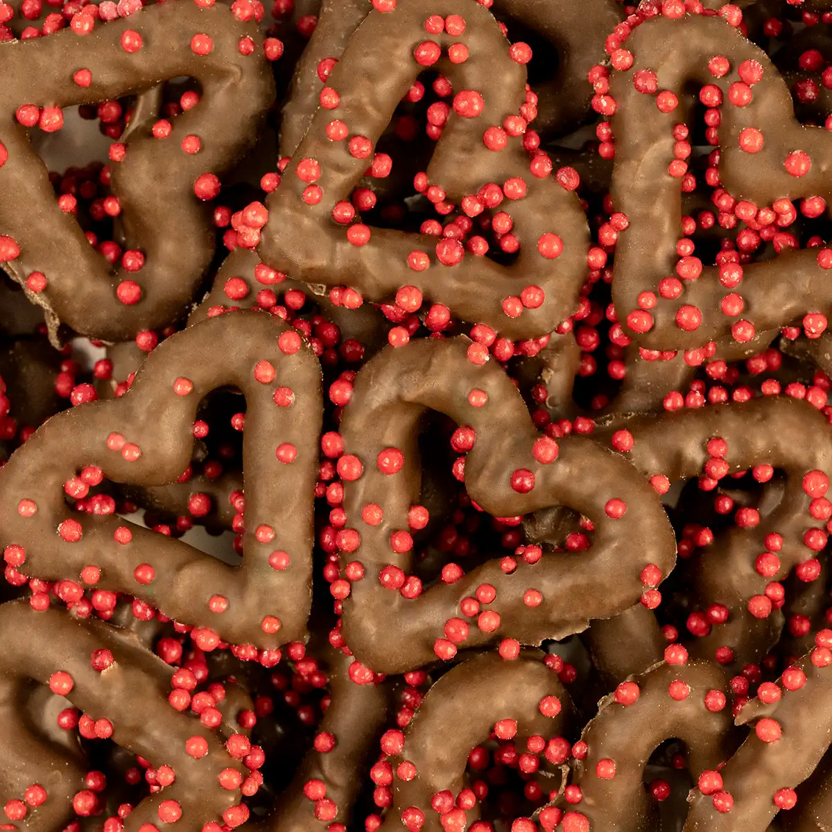 MILK CHOCOLATE HEART PRETZELS W/ RED NON PAREILS